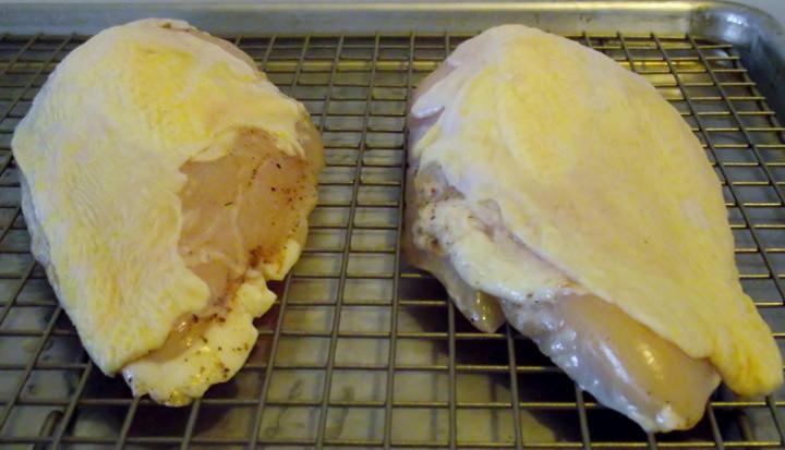 Air dried chicken breasts on a rack.