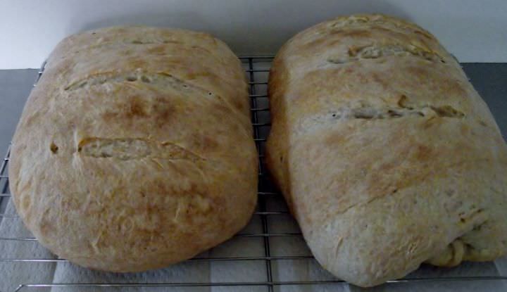 Sourdough bread cooling on a rack.