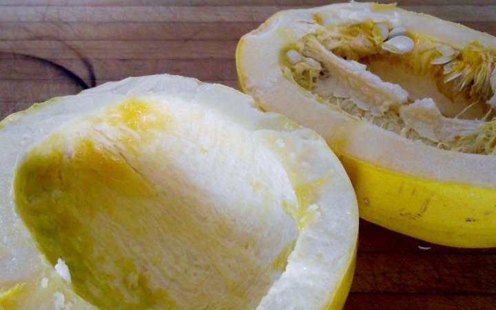 Squash split in half with the seeds and pith removed from one of the halves.