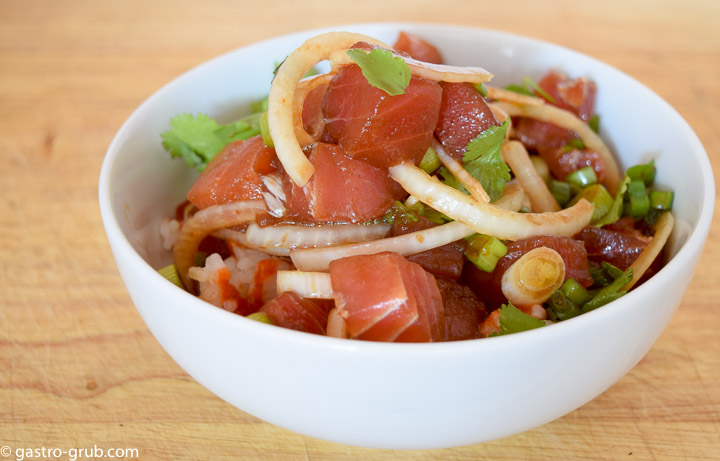 Hawaiian poke with white and green onion, cilantro, and white rice.